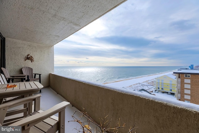 balcony with a beach view and a water view