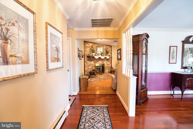 corridor with dark wood-style floors, baseboards, visible vents, and crown molding