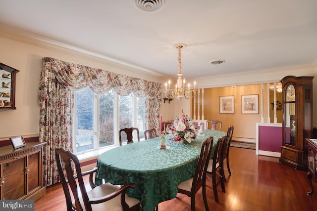 dining space featuring ornamental molding, visible vents, and wood finished floors