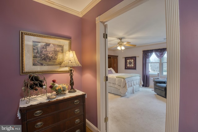 bedroom with baseboards, ceiling fan, carpet, and crown molding