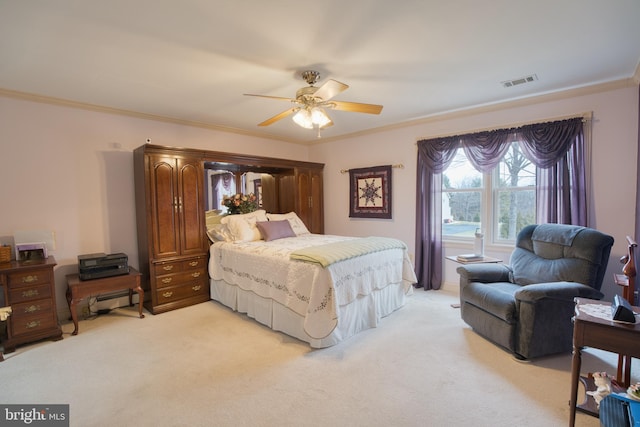 bedroom featuring light carpet, ceiling fan, visible vents, and crown molding