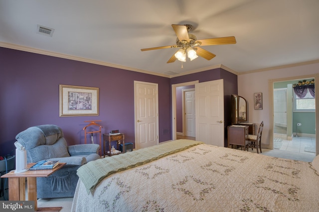 bedroom featuring baseboards, visible vents, crown molding, and ensuite bathroom