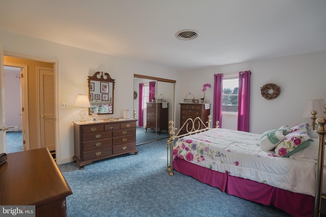 carpeted bedroom featuring visible vents and a closet