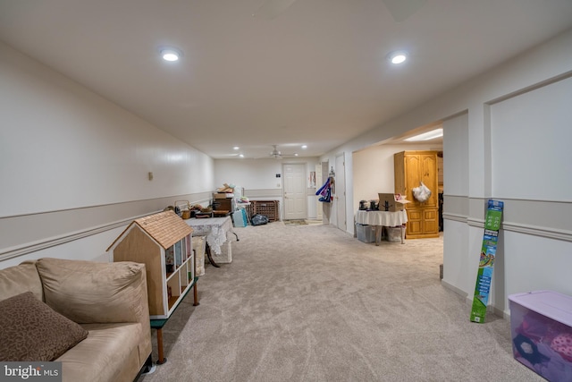 interior space with carpet, a fireplace, a ceiling fan, and recessed lighting