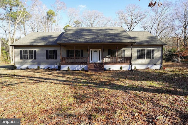 ranch-style home featuring crawl space, covered porch, and a front lawn