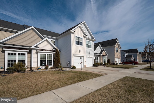 view of front of home with a garage, a residential view, concrete driveway, and a front lawn