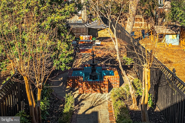 exterior space with a fenced backyard, a patio, and an outbuilding