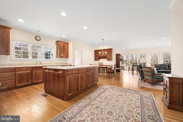 kitchen featuring a chandelier, crown molding, visible vents, and light wood-style floors