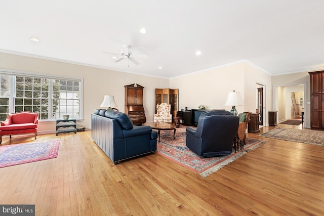 living room with ceiling fan, ornamental molding, recessed lighting, and light wood-style floors