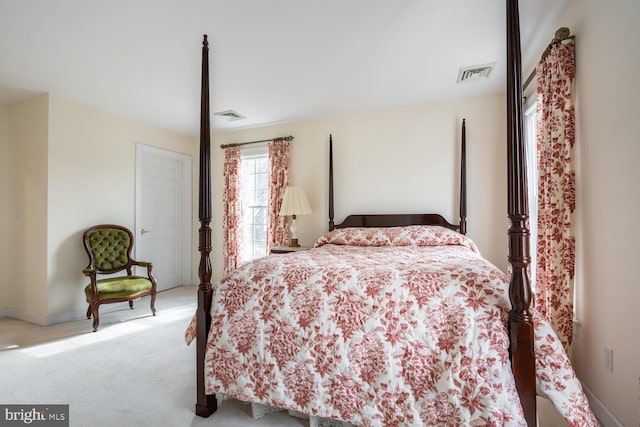 bedroom featuring baseboards, visible vents, and light colored carpet