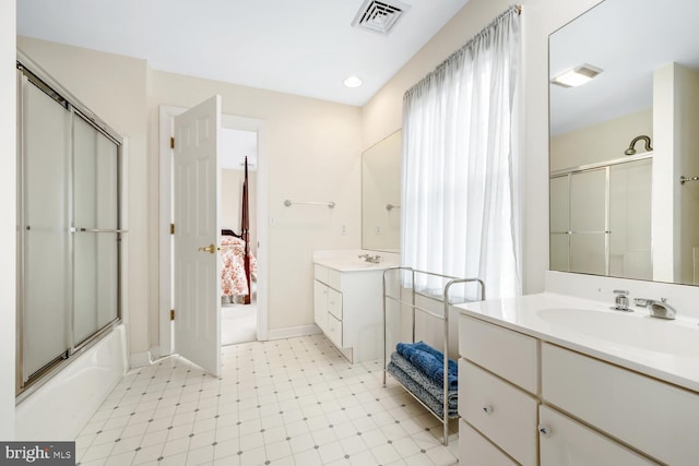 full bath with ensuite bathroom, two vanities, a sink, and visible vents