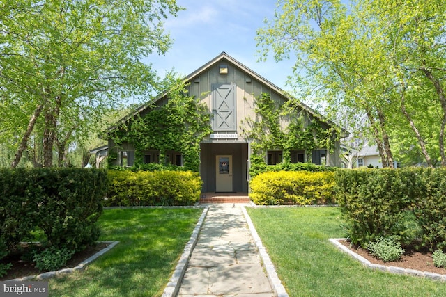 view of front of property with a front yard and a barn