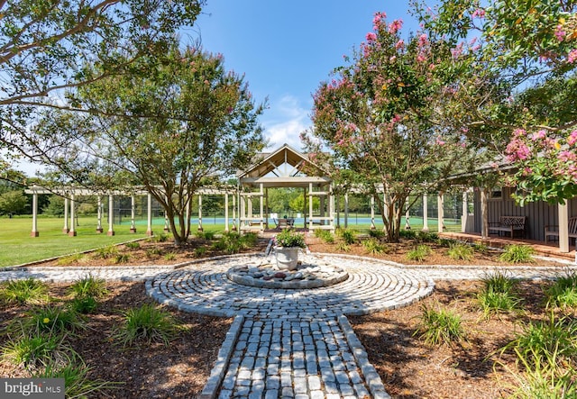 view of property's community featuring fence and a yard