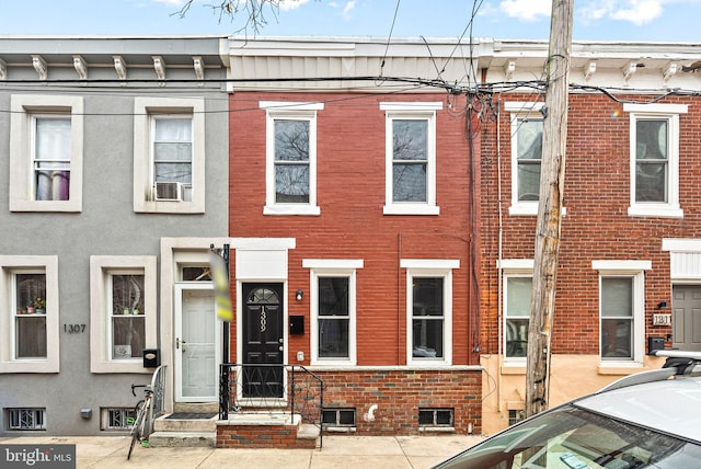 townhome / multi-family property featuring brick siding