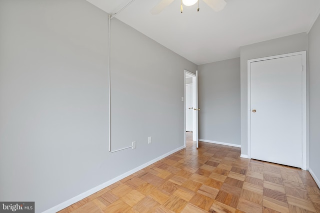 unfurnished bedroom featuring ceiling fan and baseboards