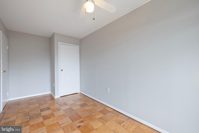 unfurnished bedroom with a ceiling fan and baseboards