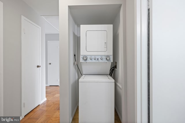 laundry area with stacked washer and dryer and laundry area