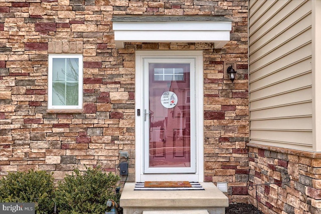 property entrance featuring brick siding