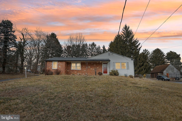 view of front of house featuring brick siding and a front lawn