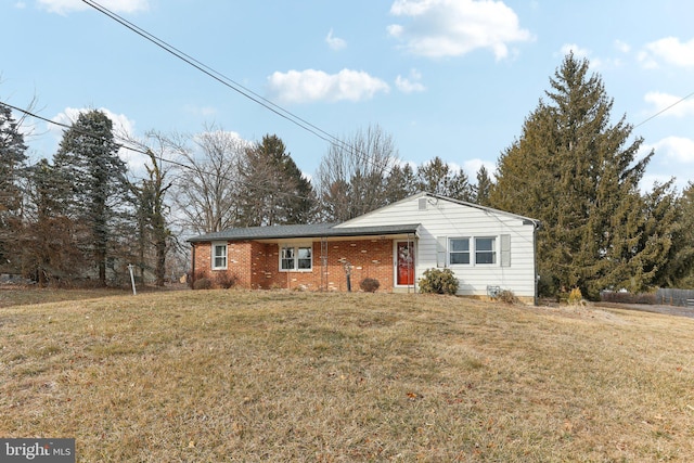 single story home featuring brick siding and a front lawn