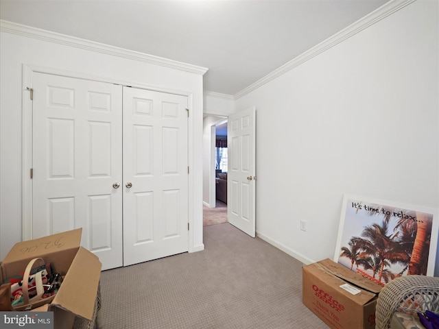 bedroom featuring carpet floors, baseboards, ornamental molding, and a closet