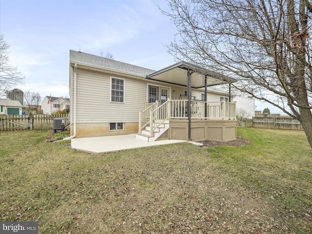 back of property featuring a patio area, a fenced backyard, a yard, and central AC