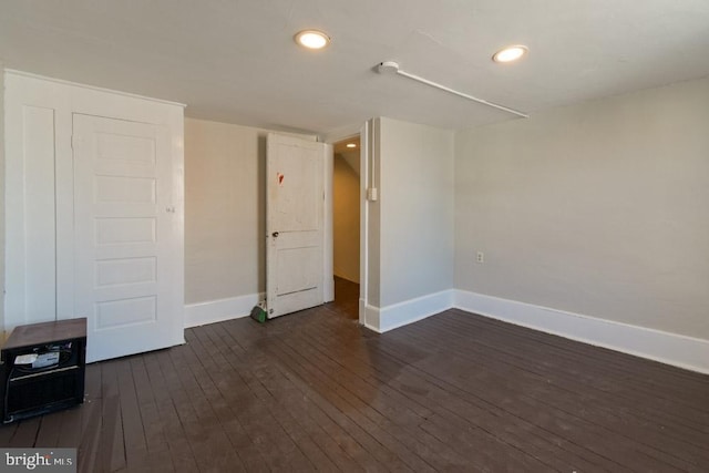 interior space featuring recessed lighting, dark wood finished floors, and baseboards