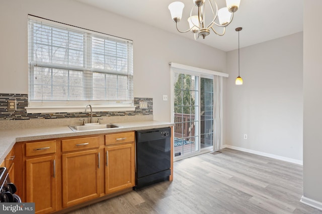 kitchen featuring dishwasher, backsplash, a sink, and brown cabinets