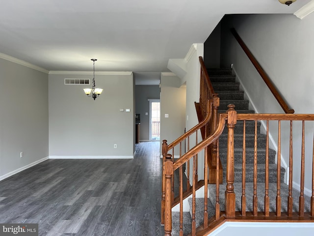 staircase featuring baseboards, visible vents, wood finished floors, crown molding, and a chandelier