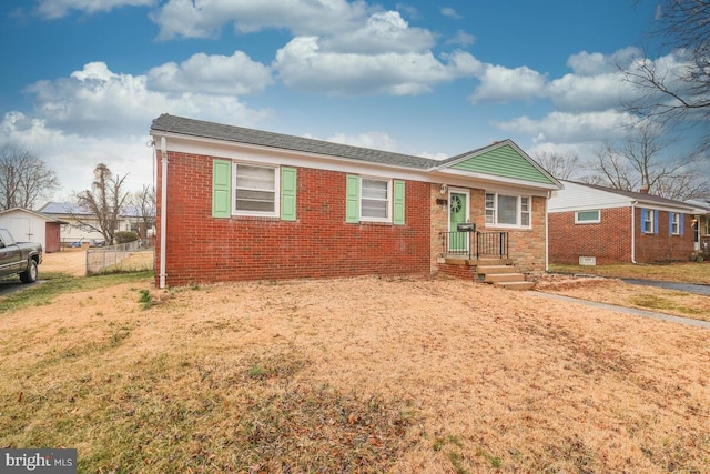 single story home featuring fence, a front lawn, and brick siding