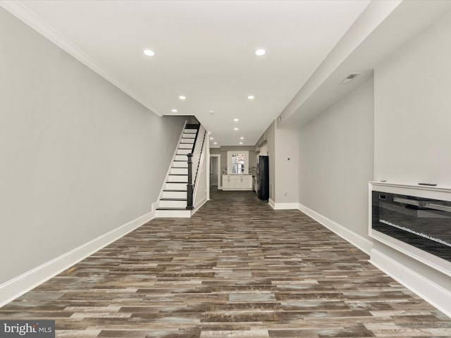 unfurnished living room featuring recessed lighting, stairway, and baseboards