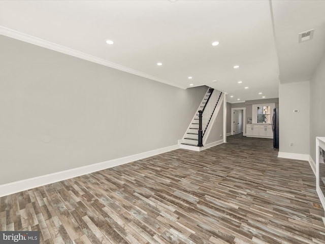 unfurnished living room with visible vents, baseboards, stairway, recessed lighting, and wood finished floors