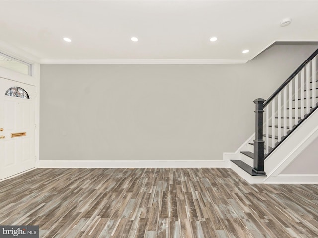 entryway with recessed lighting, baseboards, wood finished floors, and ornamental molding