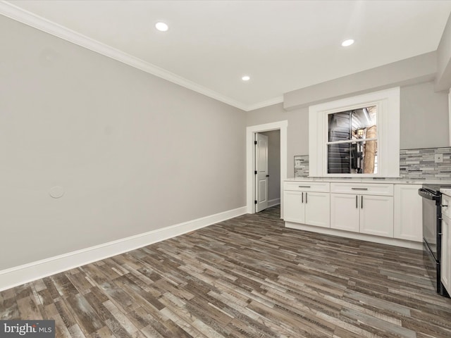 interior space with decorative backsplash, dark wood-type flooring, baseboards, and ornamental molding