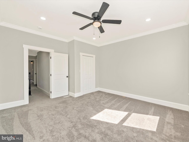 unfurnished bedroom featuring recessed lighting, baseboards, carpet floors, and crown molding