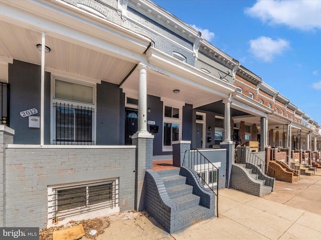 doorway to property featuring brick siding