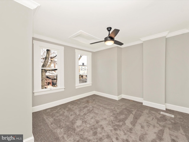 empty room with visible vents, baseboards, ornamental molding, and carpet flooring