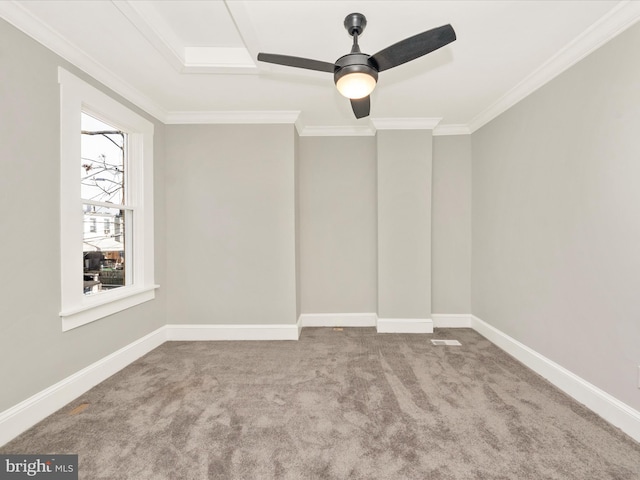 spare room featuring baseboards, a ceiling fan, ornamental molding, and carpet flooring