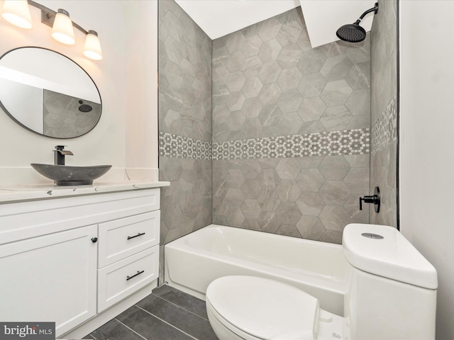 bathroom with tile patterned flooring, toilet, vanity, and bathtub / shower combination