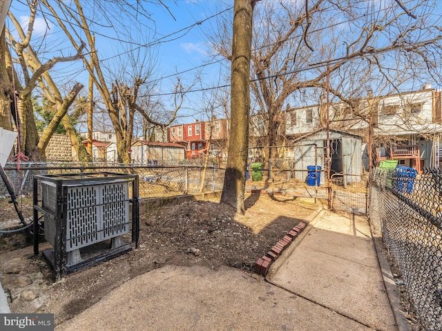 view of yard with a gate, cooling unit, and fence