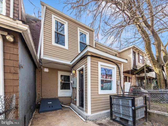 exterior space with central AC unit and fence