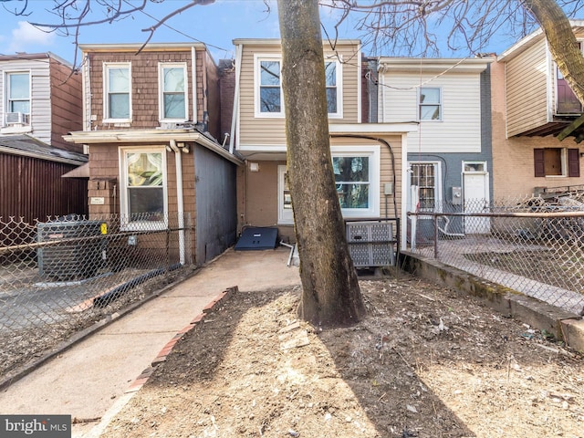 rear view of house with fence