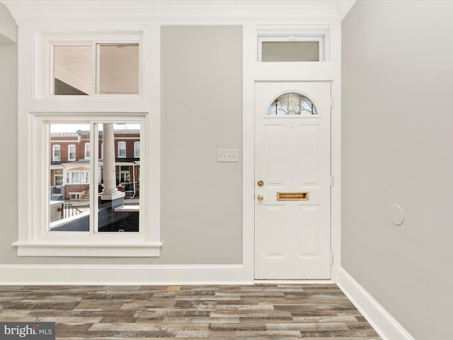 entryway featuring baseboards and wood finished floors