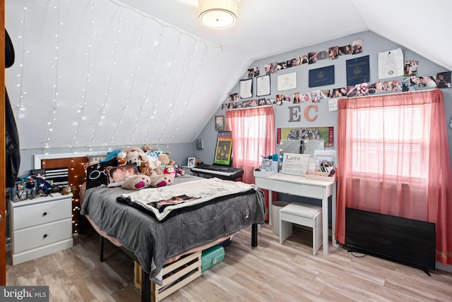 bedroom featuring lofted ceiling and light wood finished floors