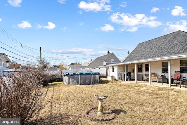 view of yard with a fenced in pool and a patio