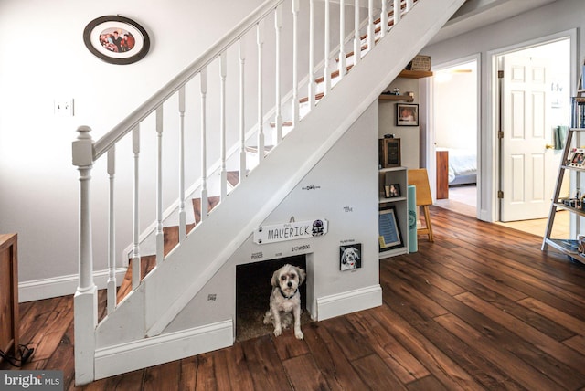 staircase featuring hardwood / wood-style flooring and baseboards