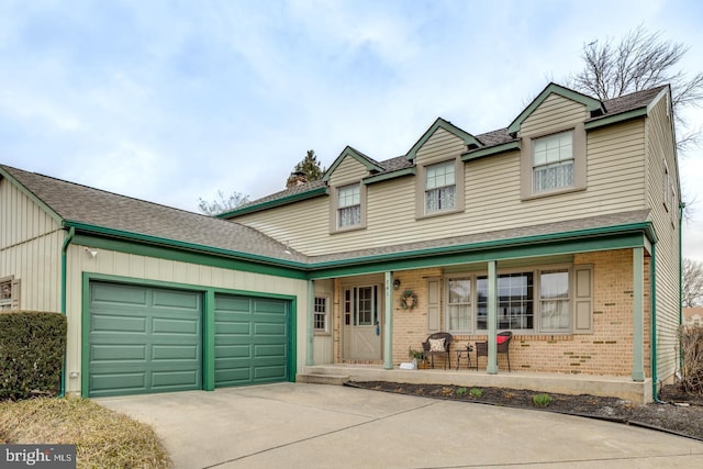 traditional home featuring driveway, a garage, a chimney, a porch, and brick siding