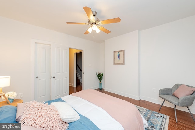 bedroom featuring wood finished floors, a ceiling fan, and baseboards