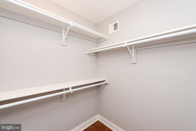 walk in closet with visible vents and wood finished floors