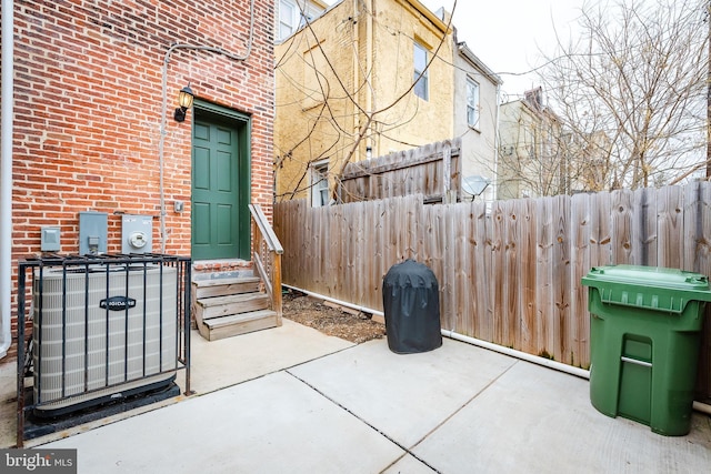 view of patio / terrace featuring fence and central AC unit